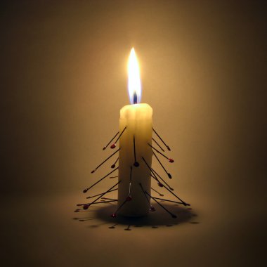 Burning candle larded with needles clipart