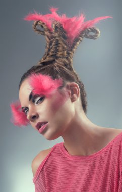 Beauty portrait of young woman with pink feathers and hairstyle clipart