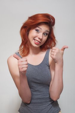 Portrait of young smiling girl. Approving gesture clipart