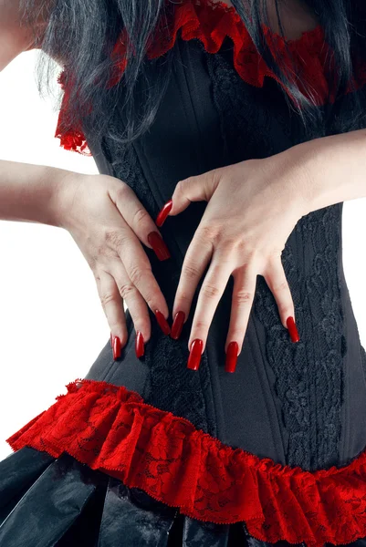Sexy chica en negro y rojo corsé falda aislado sobre fondo blanco — Foto de Stock