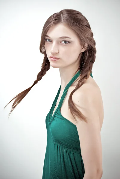 Studio portrait of attractive girl in green outfit with pigtails — Stock Photo, Image