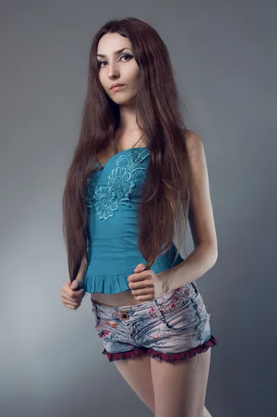 Woman in blue corset and jeans shorts — Stock Photo, Image