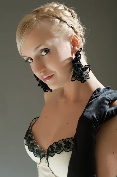 Studio portrait of blonde woman in white dress and black gloves — Stock Photo, Image