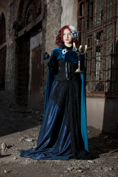 Gothic redhead woman walking with candle — Stock Photo, Image