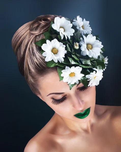 Beauty portrait of young woman face with green fresh flowers — Stock Photo, Image