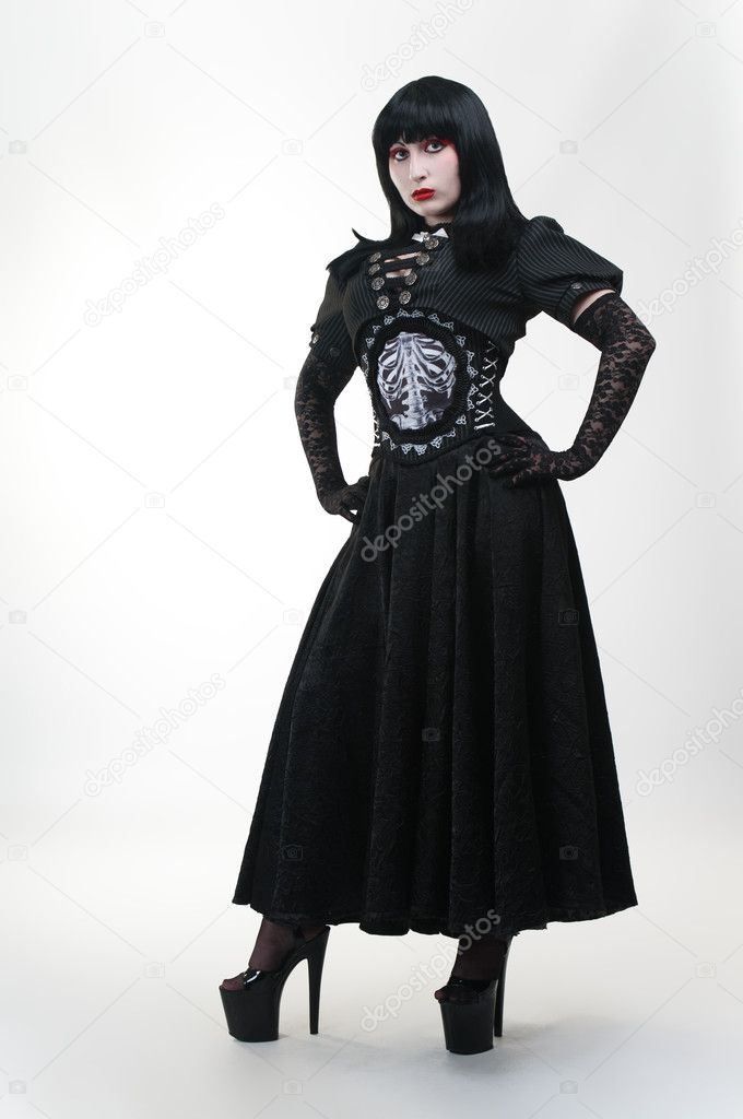 Gothic vampire girl in black dress on white background