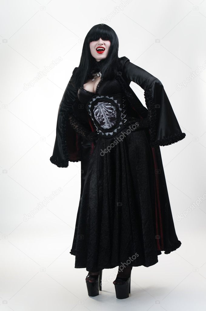 Medieval vampire girl in black dress on white