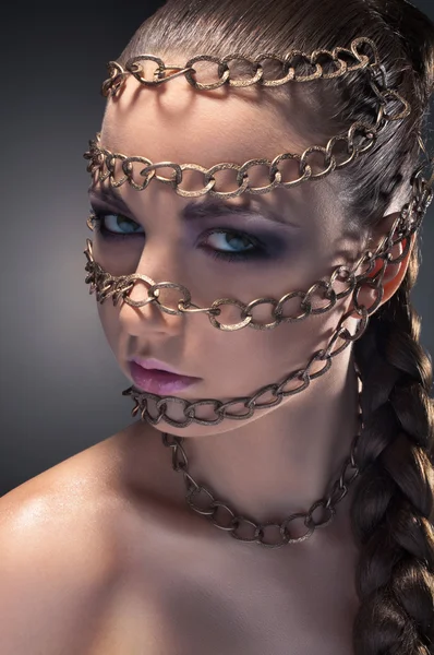 Studio beauty portrait. Face in chains — Stok fotoğraf