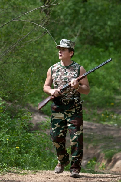 Hunter andando com rifle — Fotografia de Stock