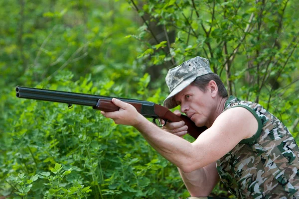 Hunter in forest with gun in hand — Stock Photo, Image