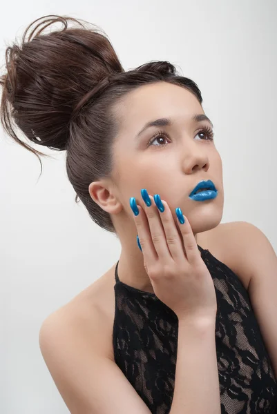 Nuori nainen siniset kynnet ja huulet eristetty valkoisella taustalla — kuvapankkivalokuva