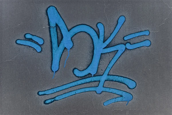Espray de graffiti azul pintado en una pared . —  Fotos de Stock