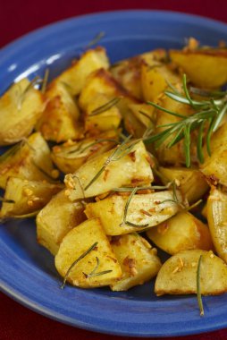 Baked potatoes with rosemary and garlic clipart