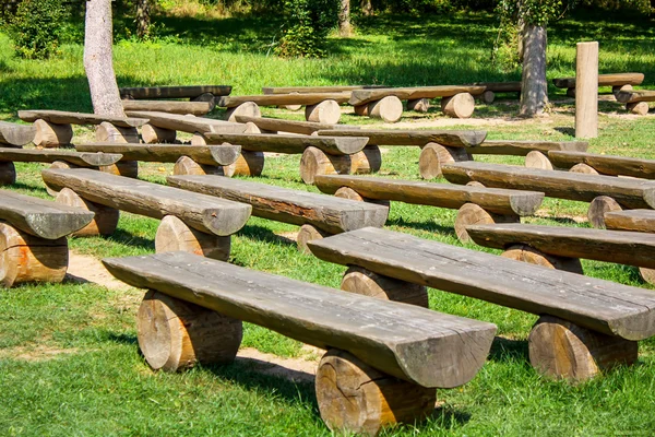 Outdoor wood benches on green lawn — Stock Photo, Image