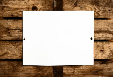 Blank paper on wooden wall clipart