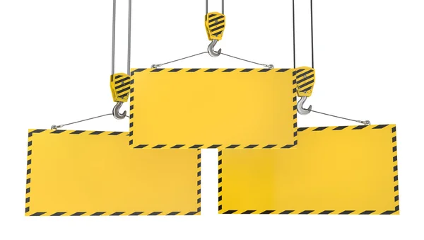 Três ganchos de guindaste com placas amarelas em branco — Fotografia de Stock