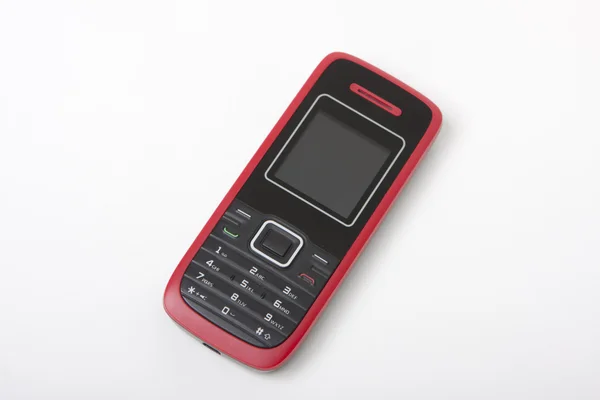 赤い携帯電話ένα ρολό ψωμιού σε χαρτοπετσέτα στο ξύλινο τραπέζι — ストック写真