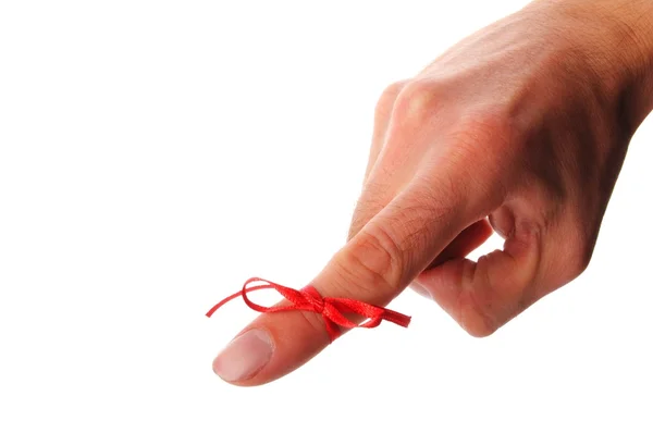 Red bow on male finger — Stock Photo, Image