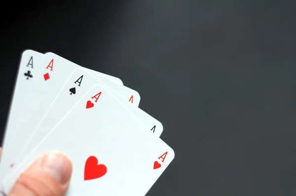 Hand holding four aces — Stock Photo, Image