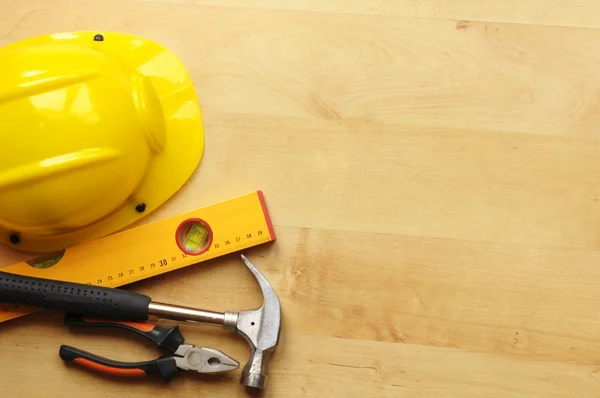 Hard hat and tool — Stock Photo, Image