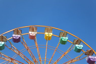 Ferris wheel and blue sky background clipart