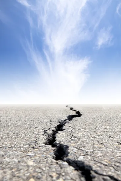 Cracked road with cloud background — Stock Photo, Image