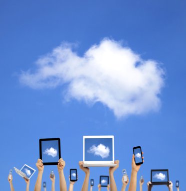 Cloud computing concept.hands holding computer laptop smart phone tablet and touch pad clipart