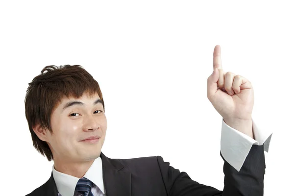 Mosolyogva rámutatva ázsiai üzletember és elkülönített fehér — Stock Fotó