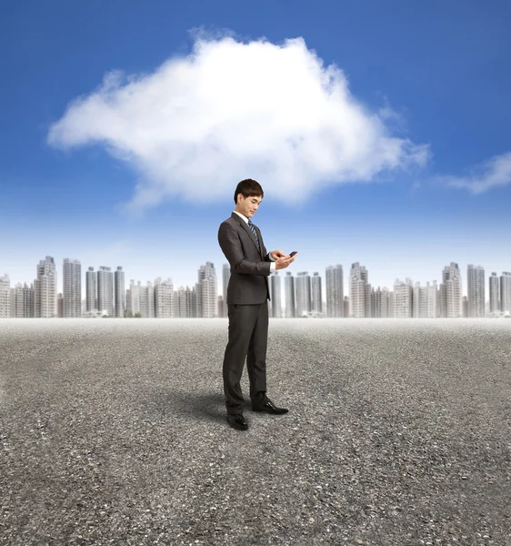 Businessman holding smart phone with cloud computing background — Stock Photo, Image