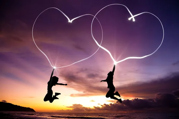 Young couple drawing hearts — Stok fotoğraf