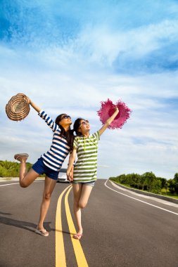 Two girls having fun on the road trip at summertime clipart