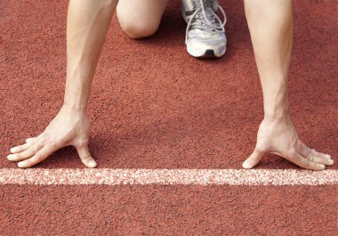 Athlete at the start line of the stadium clipart