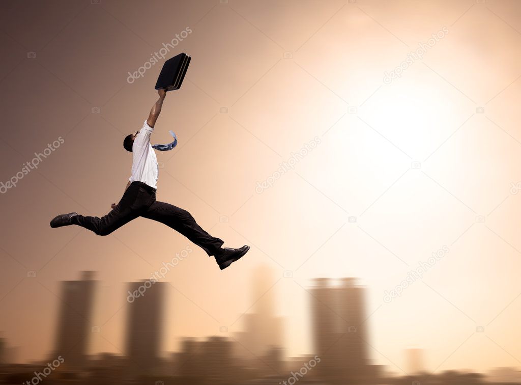 Excited Businessman running with cityscape background at morning