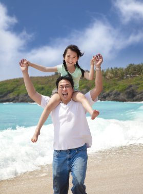 Happy girl and father on the beach clipart