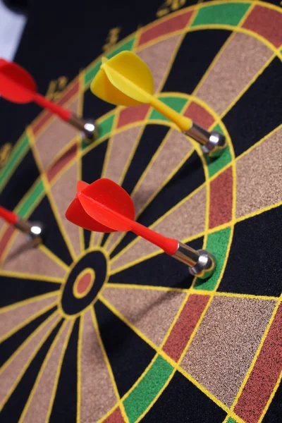 Dartboard with yellow and red magnetic darts — Stock Photo, Image