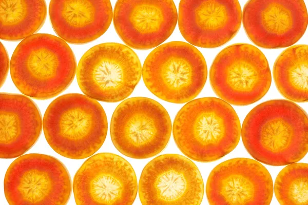 Морквяний фон на білому з підсвічуванням / макро — стокове фото