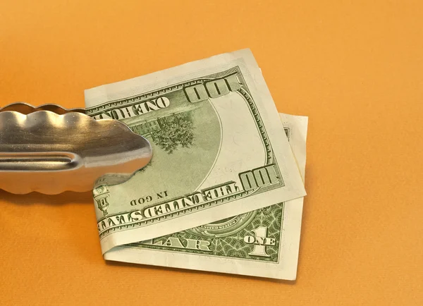 Clamp of kitchen with dollars — Stock Photo, Image