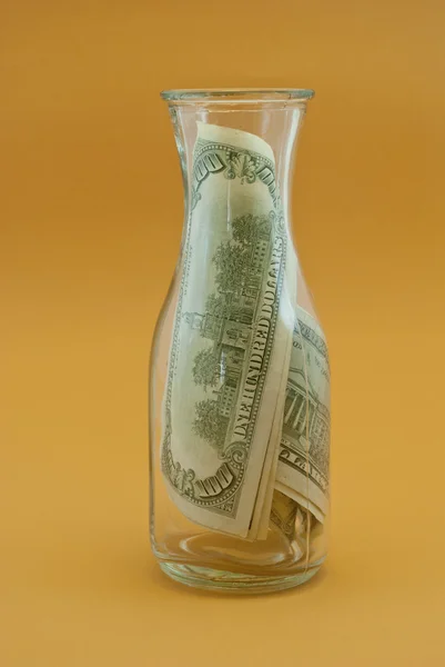 Bottle with dollars — Stock Photo, Image