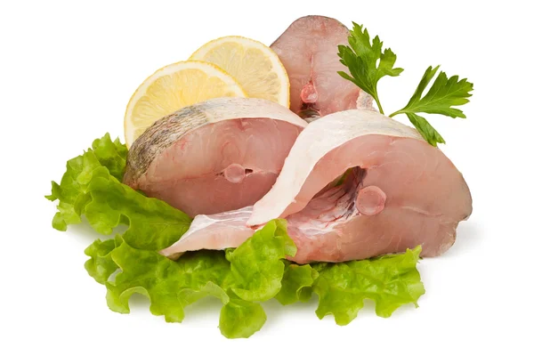 Cut fish on lettuce leaves — Stock Photo, Image