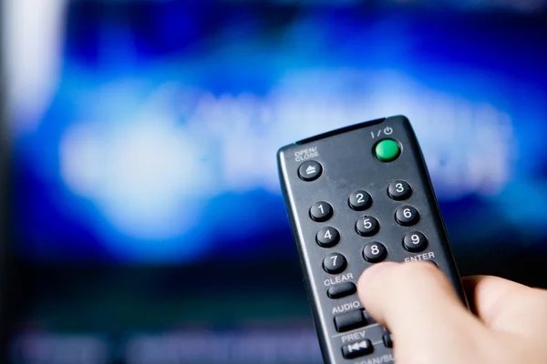 Hand holding a remote control — Stock Photo, Image