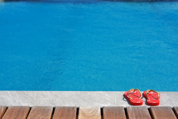 Sandals by the swimming pool — Stock Photo, Image