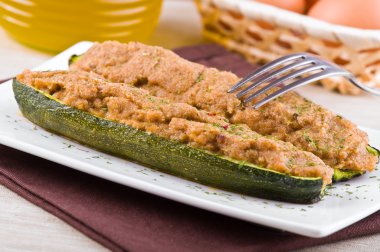 Stuffed zucchini halves. clipart