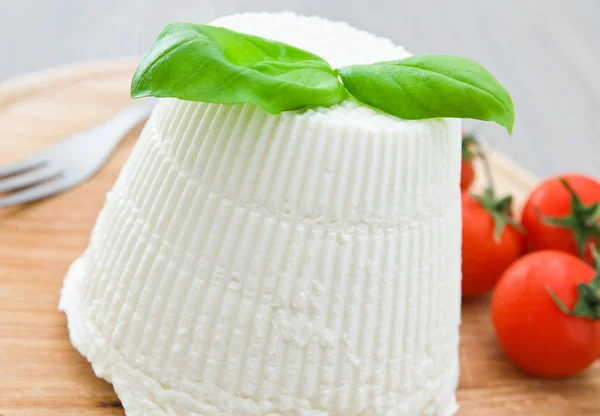 stock image Ricotta cheese with basil leaves.