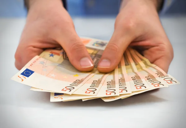 Hands with stack of fifty euro banknotes. — Stock Photo, Image