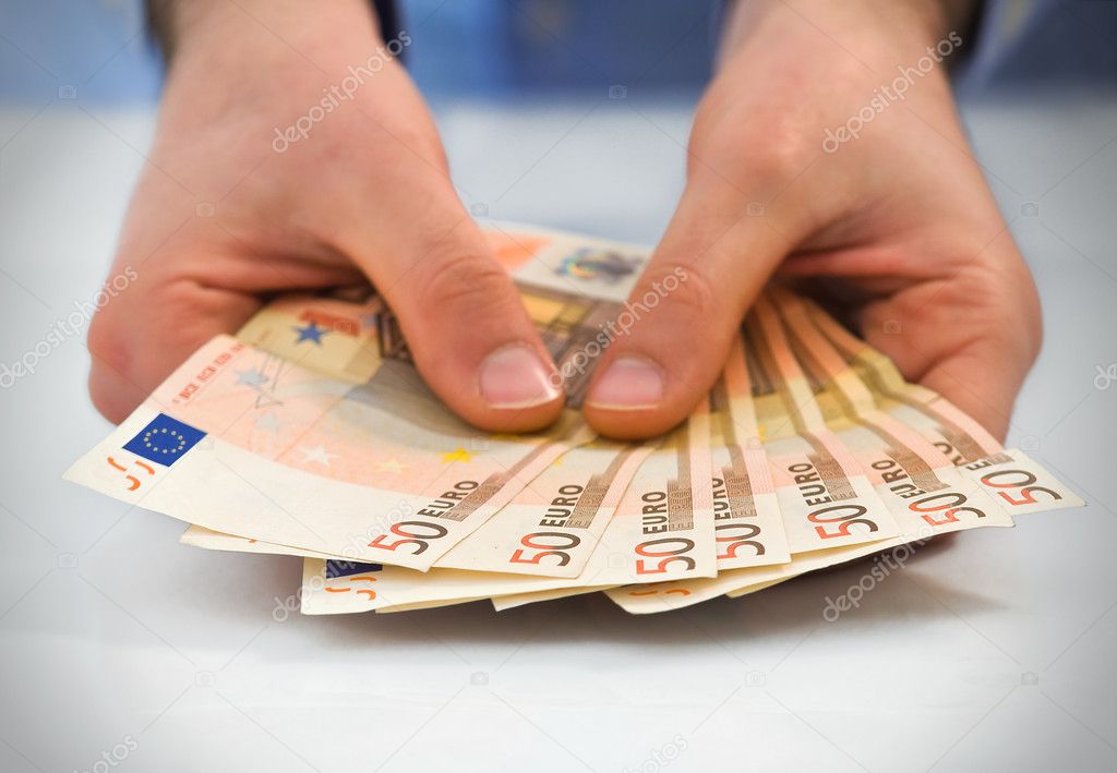 Hands with stack of fifty euro banknotes.