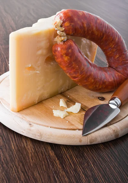 Parmesan cheese piece with spicy sausage. — Stock Photo, Image