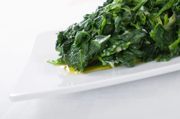 stock image Boiled spinach on white dish.