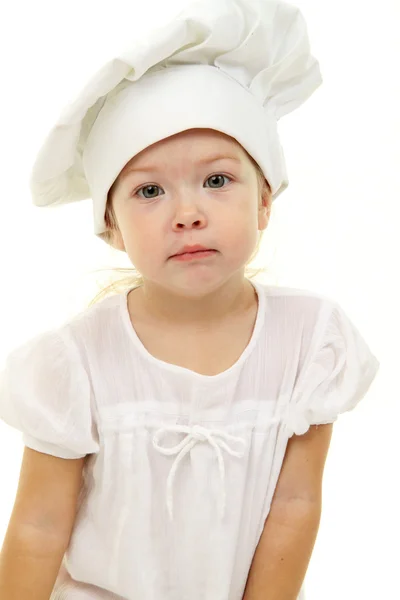 Baby flicka i cook hatten Stockbild