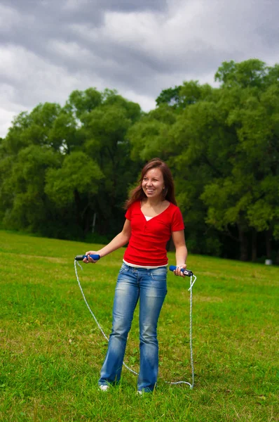 Young woman with skipping rope — Stock Photo, Image