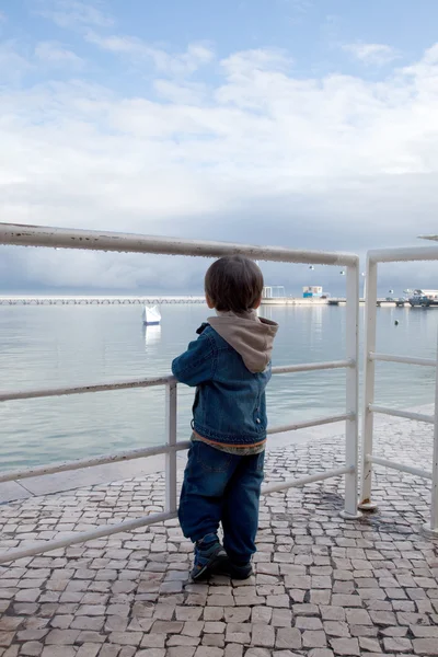 stock image A small boy standing near Oceanarium, Lisbon, Portugal